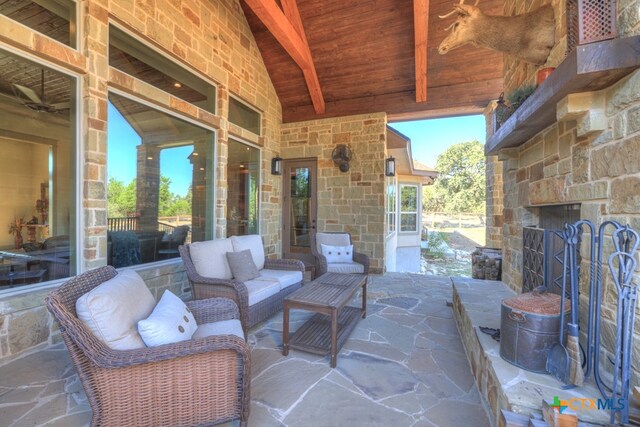 view of patio featuring an outdoor living space with a fireplace