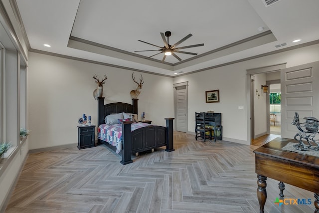 bedroom featuring crown molding, ceiling fan, a tray ceiling, and light parquet flooring