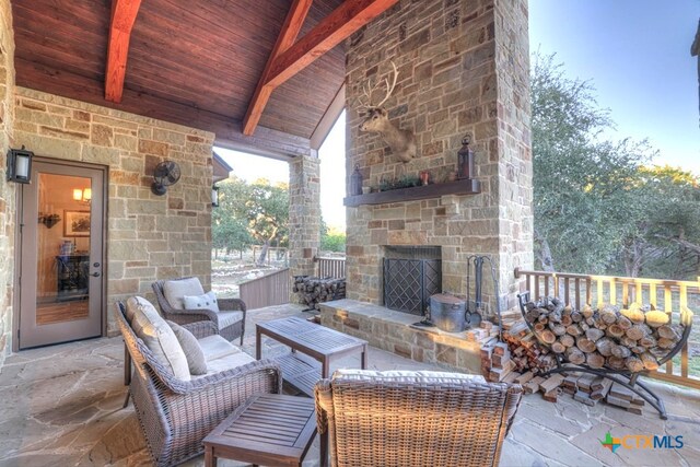 view of patio featuring an outdoor living space with a fireplace