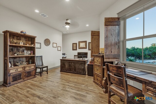 office space with ceiling fan and light hardwood / wood-style flooring