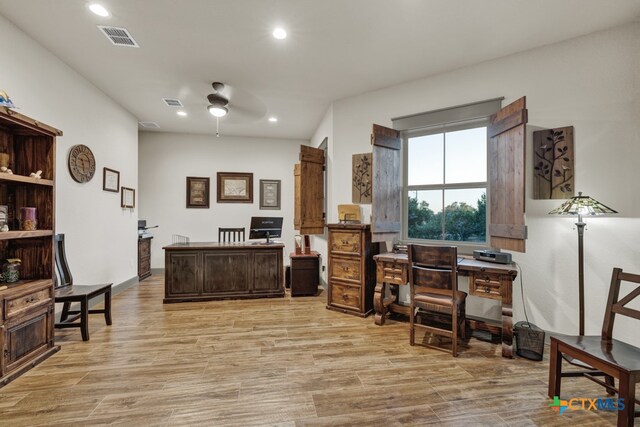 home office featuring ceiling fan and light hardwood / wood-style floors