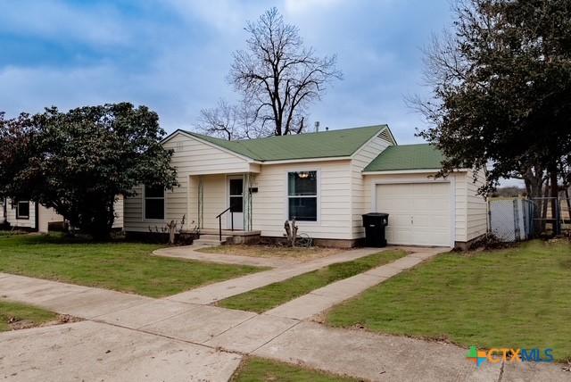 1710 S 15th St, Temple, TX 76504 - ranch-style home with an attached garage, driveway, and a front yard