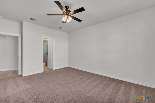 unfurnished bedroom with baseboards, visible vents, a ceiling fan, and light colored carpet