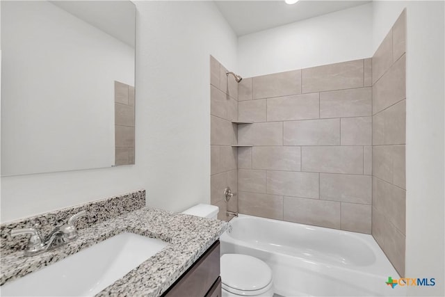 full bathroom featuring washtub / shower combination, vanity, and toilet