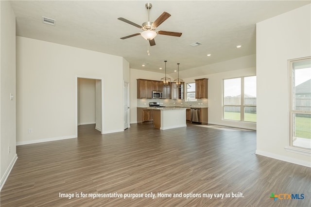 unfurnished living room featuring ceiling fan and dark hardwood / wood-style floors