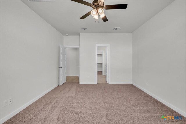 empty room with carpet flooring, ceiling fan, and vaulted ceiling