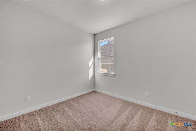 carpeted spare room with baseboards