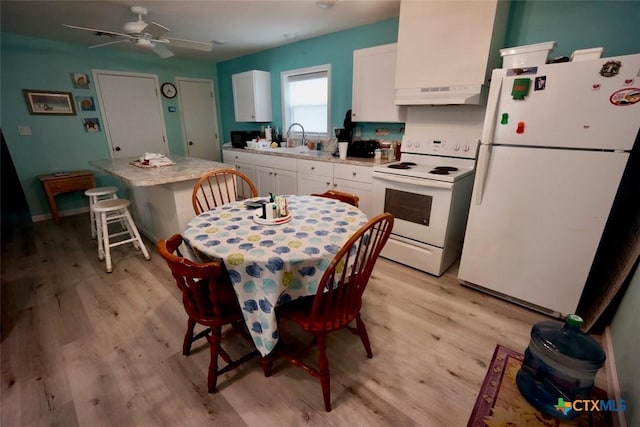 kitchen featuring white cabinetry, light wood-type flooring, white appliances, and sink