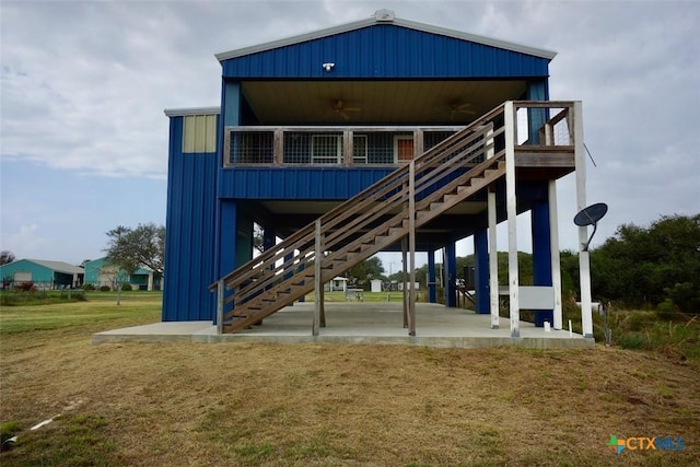 rear view of house with ceiling fan and a patio