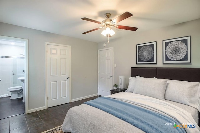 1504 Phyllis Dr, Copperas Cove, TX 76522 - bedroom with ensuite bathroom, dark tile patterned flooring, and ceiling fan