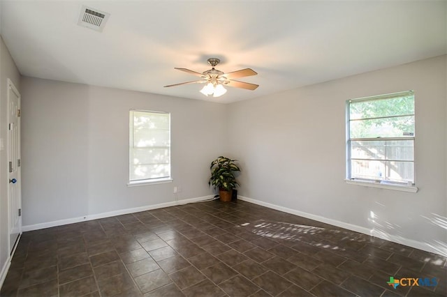 1504 Phyllis Dr, Copperas Cove, TX 76522 - empty room with ceiling fan and dark tile patterned floors