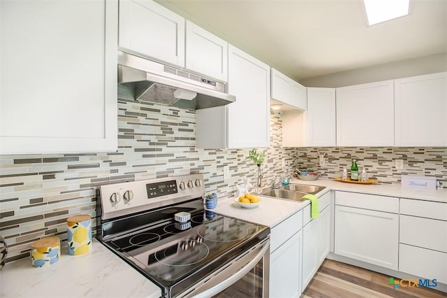 1504 Phyllis Dr, Copperas Cove, TX 76522 - kitchen featuring electric stove, under cabinet range hood, backsplash, and light countertops