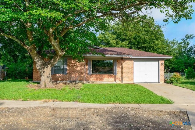 1504 Phyllis Dr, Copperas Cove, TX 76522 - single story home with concrete driveway, brick siding, a garage, and a front yard