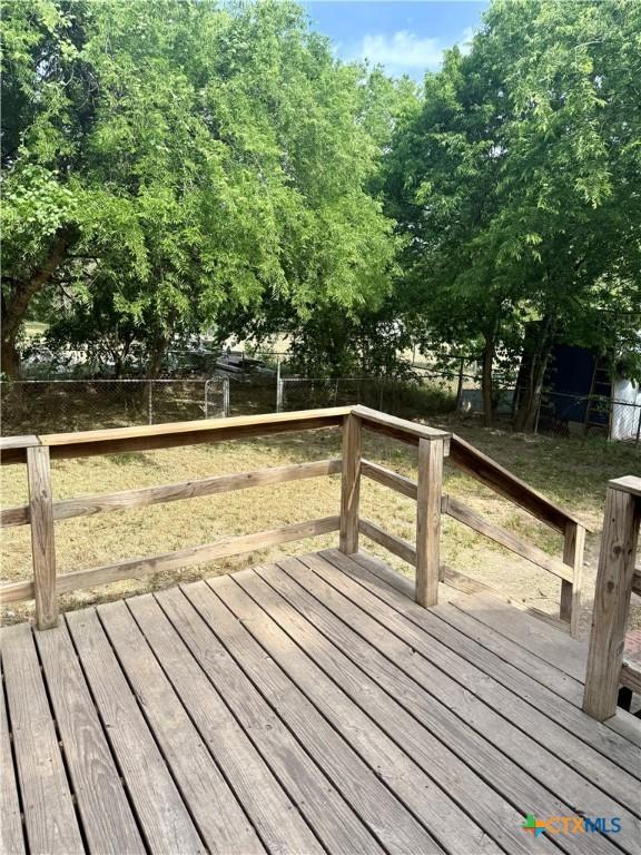 wooden terrace featuring a fenced backyard