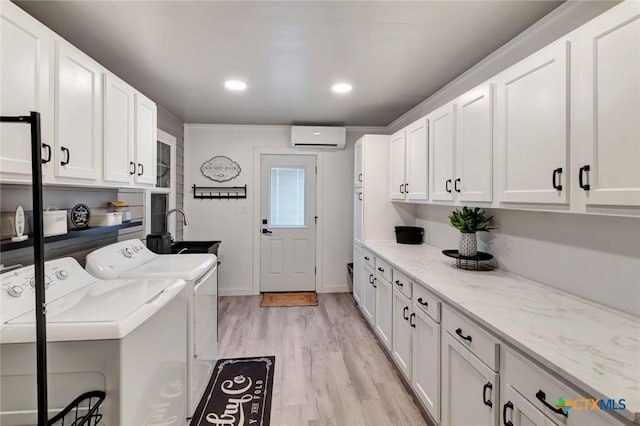 612 W Jackson Ave, Port Oconnor, TX 77982 - clothes washing area featuring washing machine and dryer, cabinet space, a wall mounted air conditioner, light wood finished floors, and recessed lighting