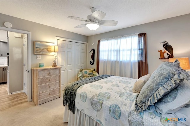 612 W Jackson Ave, Port Oconnor, TX 77982 - bedroom featuring a closet, light carpet, and a ceiling fan