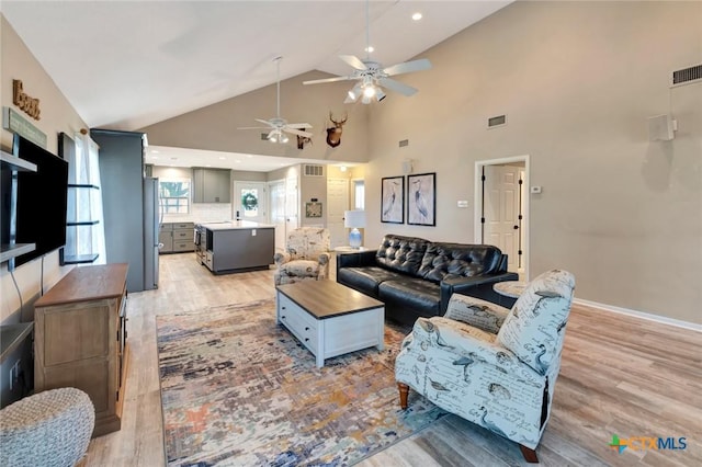 612 W Jackson Ave, Port Oconnor, TX 77982 - living room featuring ceiling fan, light wood-style floors, plenty of natural light, high vaulted ceiling, and recessed lighting
