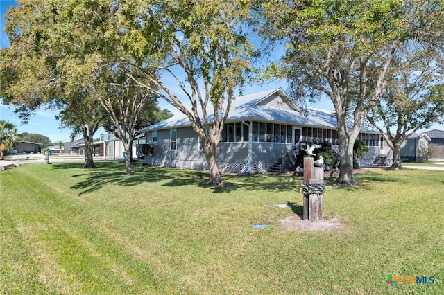 612 W Jackson Ave, Port Oconnor, TX 77982 - view of home's exterior with a yard and a sunroom
