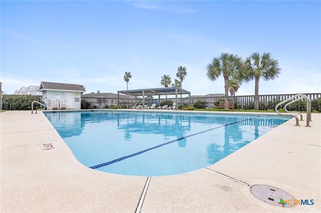 30 Nassau Dr, Rockport, TX 78382 - community pool with an outdoor structure, fence, and a patio