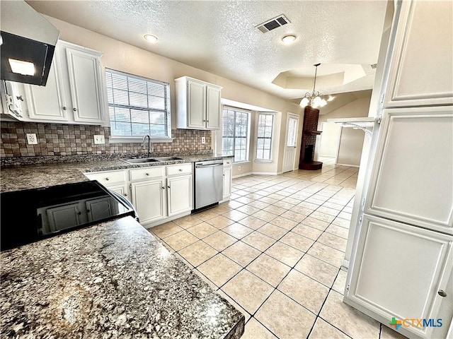 kitchen featuring tasteful backsplash, sink, dishwasher, white cabinetry, and light tile patterned flooring