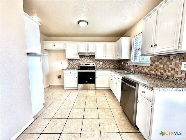 kitchen with white cabinetry, sink, backsplash, light tile patterned flooring, and appliances with stainless steel finishes