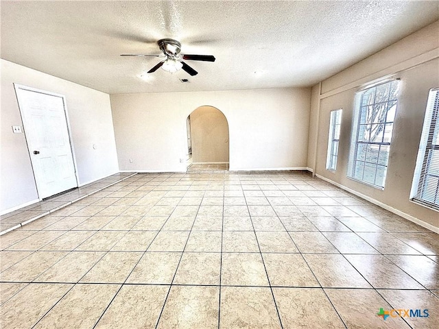 tiled spare room featuring ceiling fan and a textured ceiling