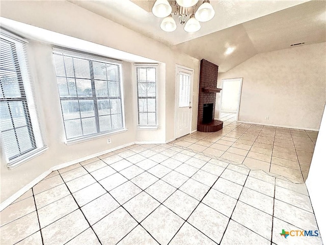 unfurnished living room featuring a brick fireplace, light tile patterned flooring, vaulted ceiling, and a notable chandelier