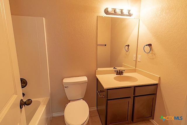 bathroom featuring vanity, tile patterned floors, and toilet