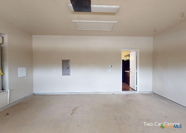 empty room with electric panel and a textured ceiling