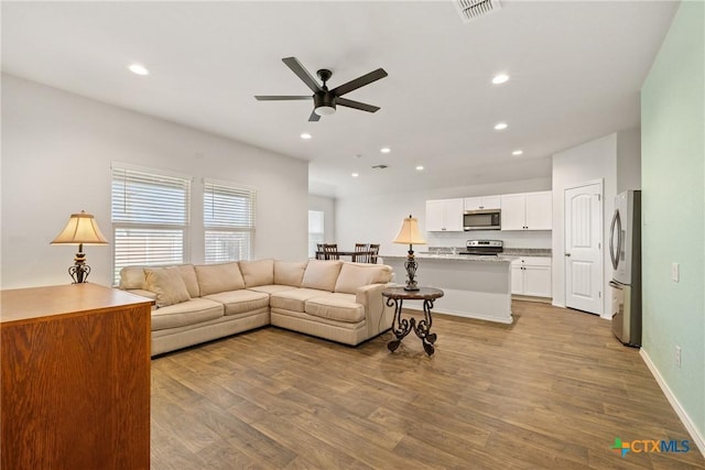 837 Margay Loop, Seguin, TX 78155 - living area featuring a ceiling fan, wood finished floors, recessed lighting, and baseboards