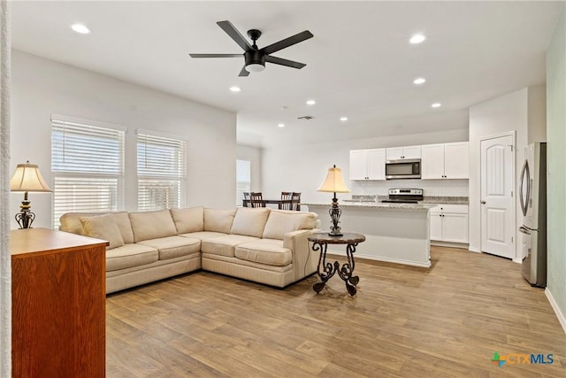 837 Margay Loop, Seguin, TX 78155 - living area featuring ceiling fan, light wood finished floors, recessed lighting, and baseboards