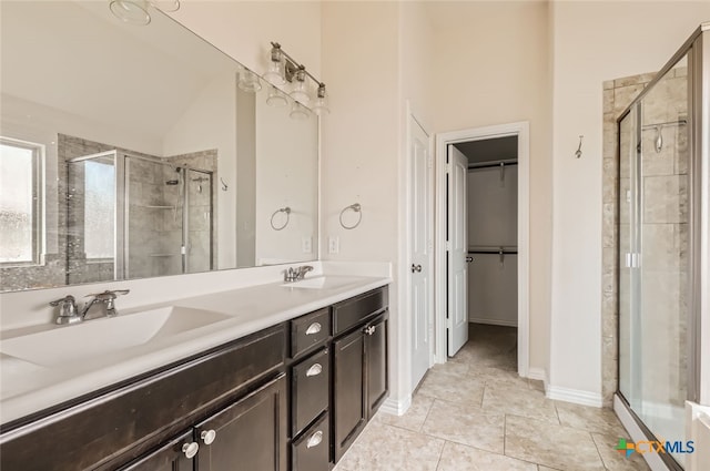 bathroom featuring vanity, tile patterned floors, and a shower with shower door