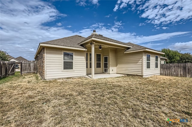 back of house with ceiling fan, a yard, and a patio