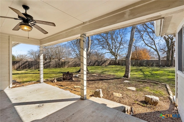 view of yard with ceiling fan and a patio area