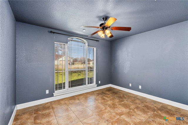 spare room featuring ceiling fan and a textured ceiling