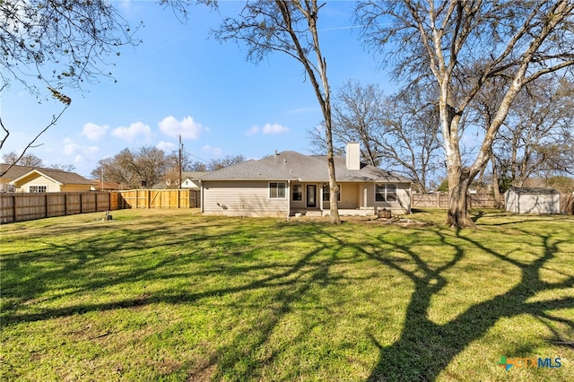 back of house with a yard