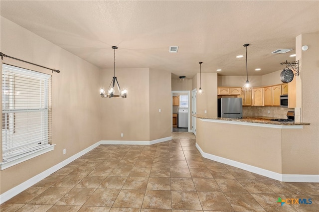 kitchen featuring backsplash, stainless steel appliances, decorative light fixtures, and light brown cabinets