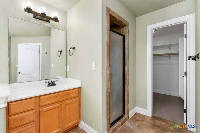 bathroom with vanity and a shower with door