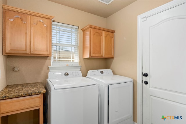 laundry area featuring cabinets and independent washer and dryer