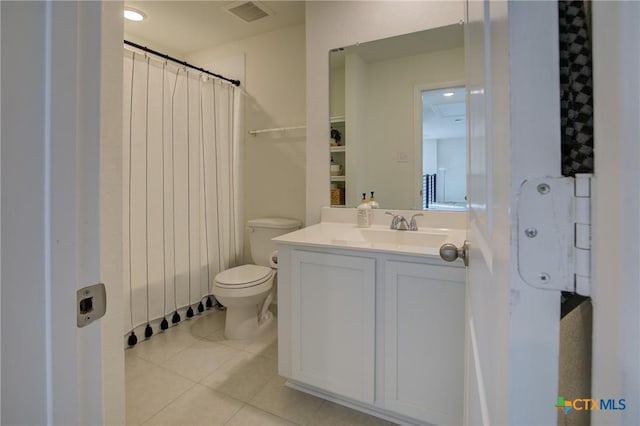 bathroom featuring tile patterned flooring, vanity, and toilet