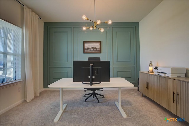 carpeted office space with a healthy amount of sunlight and a chandelier