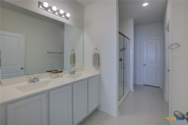 bathroom featuring tile patterned floors, vanity, and a shower with door