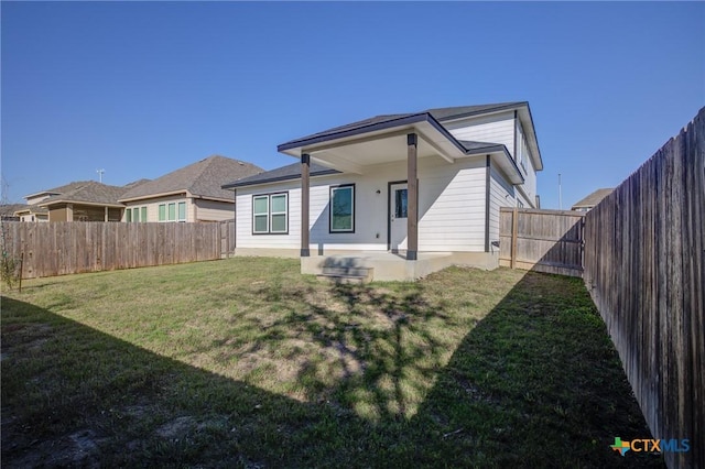 rear view of house with a yard and a patio area