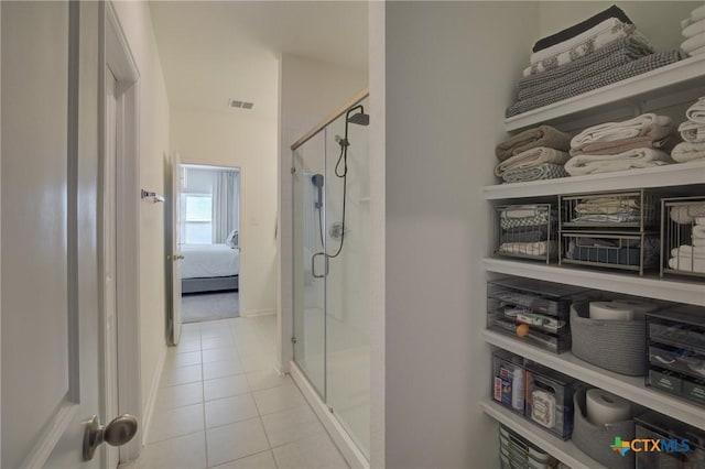 bathroom featuring tile patterned floors and a shower with door