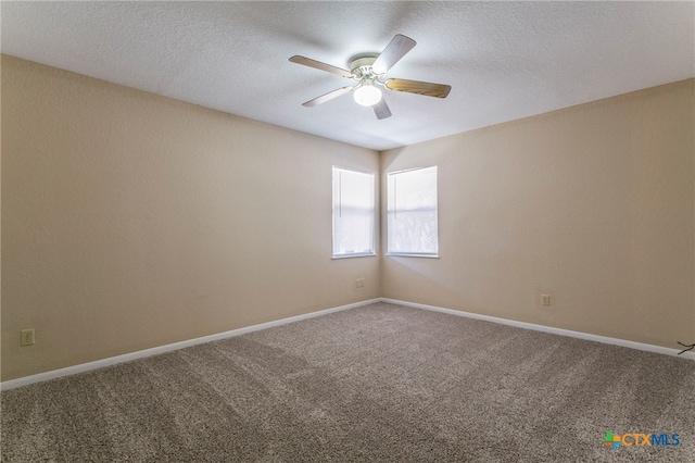 spare room with ceiling fan, carpet, and a textured ceiling