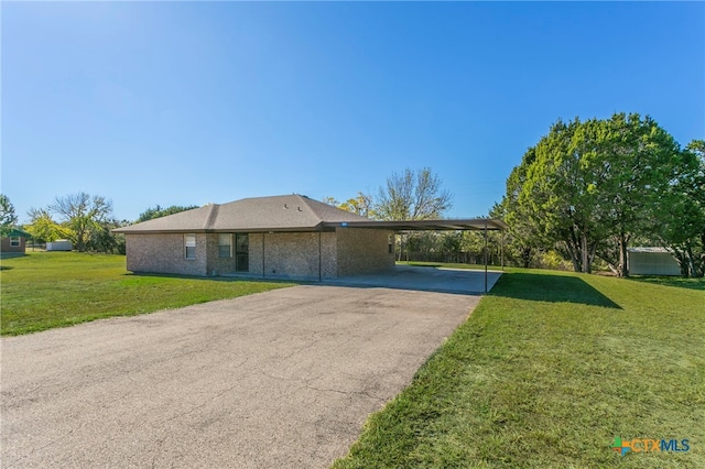 single story home with a front lawn and a carport