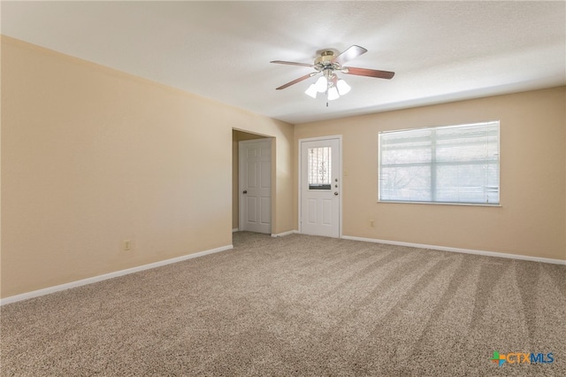 carpeted empty room featuring ceiling fan