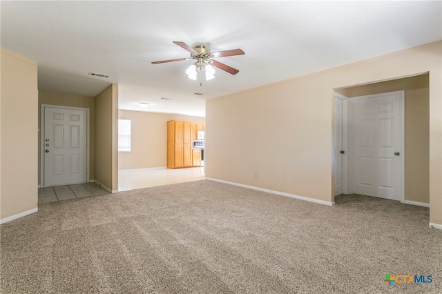 empty room with ceiling fan and light carpet