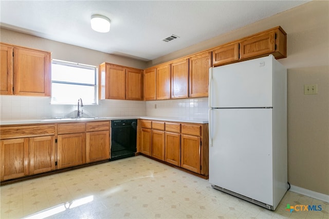 kitchen featuring dishwasher, white refrigerator, backsplash, and sink