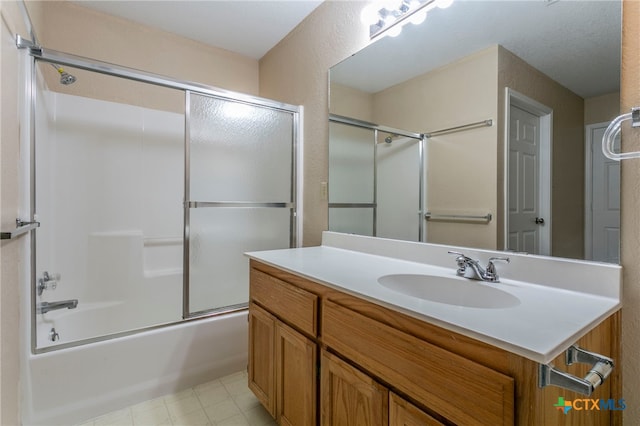 bathroom with shower / bath combination with glass door and vanity